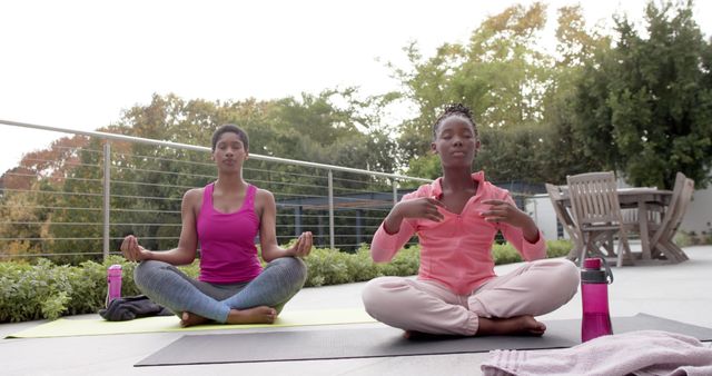 Two Women Practicing Yoga Outdoors on Patio - Download Free Stock Images Pikwizard.com