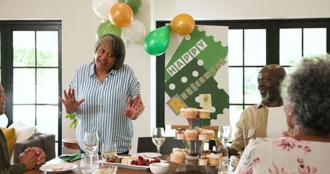 Diverse Group Celebrating Retirement Party in Living Room