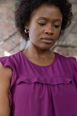 Elegant woman in purple blouse in urban loft setting