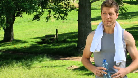 Man Relaxing with Water After Outdoor Jogging