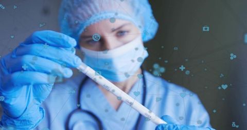 Clinician Holding Specimen Tube in PPE with Stethoscope for Laboratory Diagnostics Testing