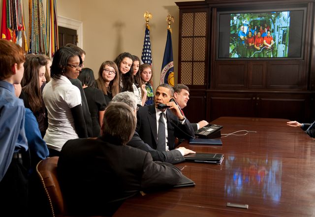 U.S. President Barack Obama, accompanied by Congressman C.A. "Dutch" Ruppersberger (D-MD) and middle school children, prepares to hand over the phone to a student to ask a question to astronauts on the International Space Station during an event in the Roosevelt Room of the White House, Wednesday, Feb. 17, 2010 in Washington. Photo Credit: (NASA/Bill Ingalls)