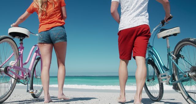 Couple Holding Bicycles on Beach, Sunny Day, Ocean Horizon - Download Free Stock Images Pikwizard.com