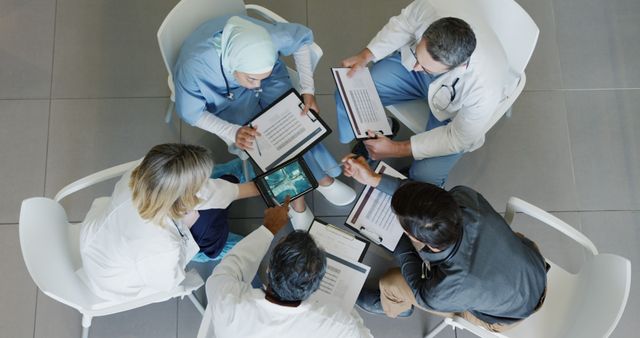 Group of Healthcare Professionals Discussing Medical Reports in Meeting - Download Free Stock Images Pikwizard.com