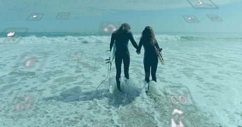 Couple Surfing with Eco-Friendly Conceptual Icons on Ocean Shore