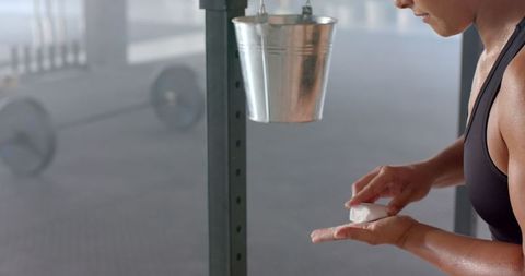 Focused Athletic Woman Preparing for Intense Workout in Gym
