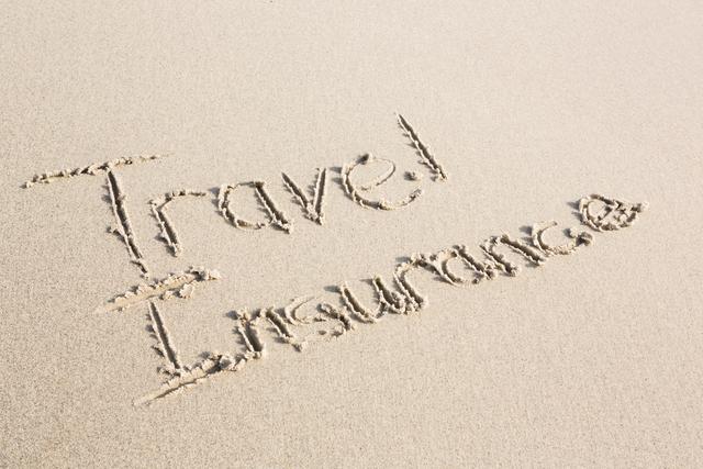 Travel Insurance written on sand at beach. Ideal for travel agencies, insurance companies, vacation planning, and promotional materials emphasizing the importance of travel insurance. Perfect for blogs, websites, and social media posts related to travel safety and preparation.