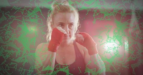 Determined woman training in gym with futuristic tech overlay