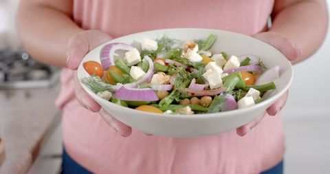 Woman Holding Fresh Feta Salad Bowl Indoors, Promoting Healthy Eating - Download Free Stock Images Pikwizard.com