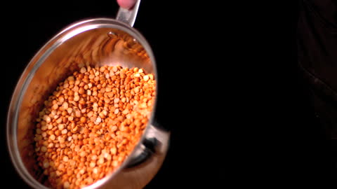 Corn Kernels Shaking in Shiny Metal Pot for Cooking