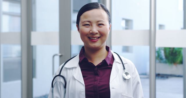 Smiling Female Doctor with Stethoscope in Hospital Corridor - Download Free Stock Images Pikwizard.com