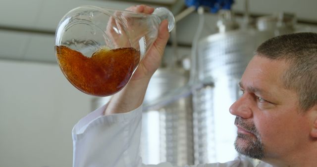 Experiments in Chemistry: Scientist Examining Liquid in Flask - Download Free Stock Images Pikwizard.com