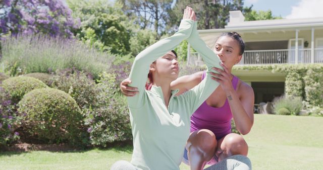 Woman Guiding Friend in Outdoor Yoga Session in Garden - Download Free Stock Images Pikwizard.com