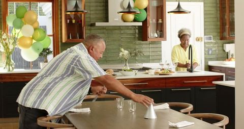 Happy Senior Couple Preparing Kitchen for Celebration