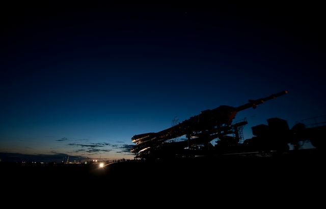 Night view of the Soyuz TMA-17 spacecraft being transported by train to the launch pad at the Baikonur Cosmodrome in Kazakhstan. Captured on December 18, 2009, the image portrays the meticulous process involved in space mission preparations. This image is ideal for articles, publications, and educational materials related to space exploration, NASA missions, and the Soyuz program.