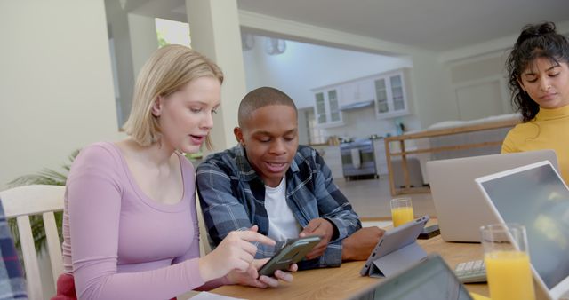 Diverse Group of Students Collaborating with Gadgets in Modern Home - Download Free Stock Images Pikwizard.com