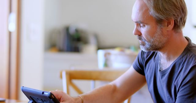 Middle Aged Man Using Tablet at Home Office - Download Free Stock Images Pikwizard.com