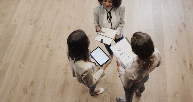 Businesswomen Strategizing with Tablets and Documents - Download Free Stock Images Pikwizard.com