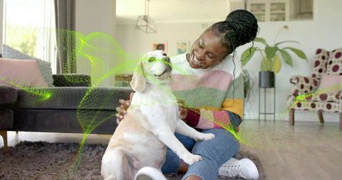 Smiling woman petting beagle on cozy living room rug with neon digital wave overlay