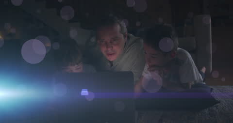 Father Enjoying Quality Time with Children Around Laptop