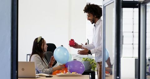 Colleagues Celebrating Birthday in Modern Office with Balloons