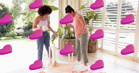 Painting wooden stool together in sunroom diy furniture makeover under natural light