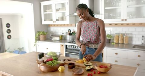 Woman Preparing Healthy Salad in Modern Home Kitchen