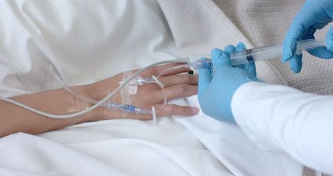Healthcare Professional Adjusting IV Line for Patient - Download Free Stock Images Pikwizard.com
