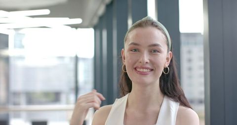 Smiling Woman in Modern Office with Elegant Décor
