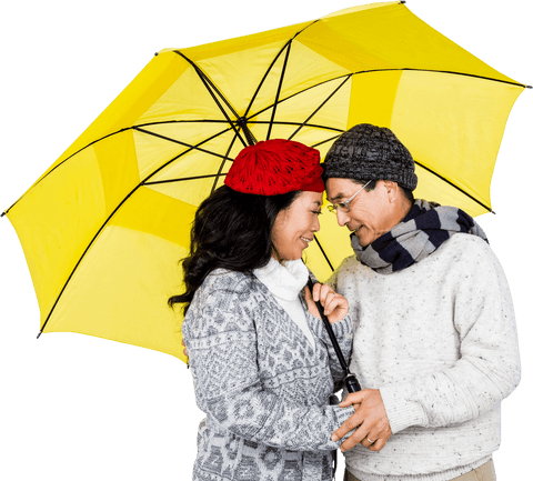 Couple in winter wear under clear yellow umbrella