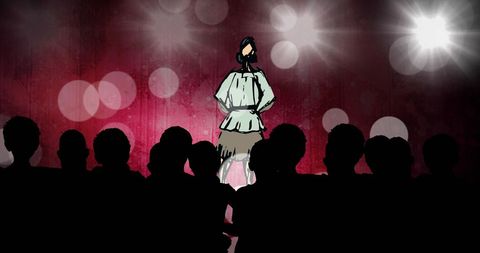 Chef on stage performing culinary show with audience