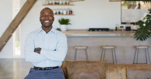 Smiling Man Relaxing in Modern Kitchen Interior