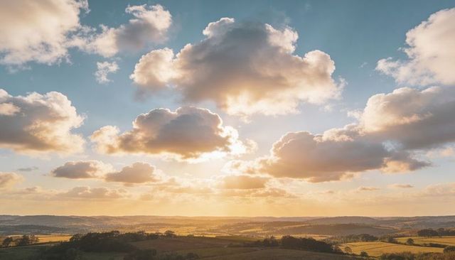 Golden sunlight streaming through dramatic clouds over rolling countryside at sunset