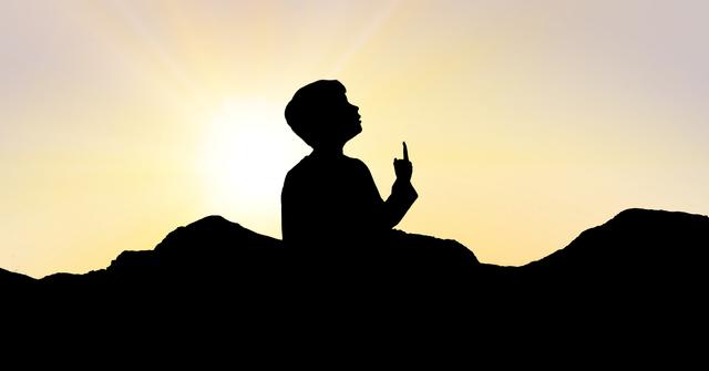 Digital composite of Silhouette boy pointing towards sky during sunset