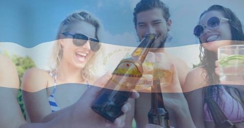 Friends Enjoying Toast with Nicaraguan Flag Overlay at Beach Gathering