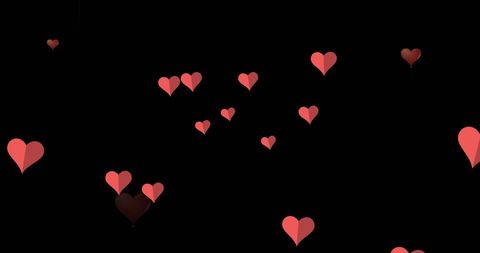 Floating red hearts on black background concept