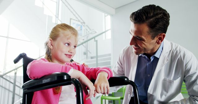 Doctor Comforting Young Girl in Wheelchair - Download Free Stock Images Pikwizard.com