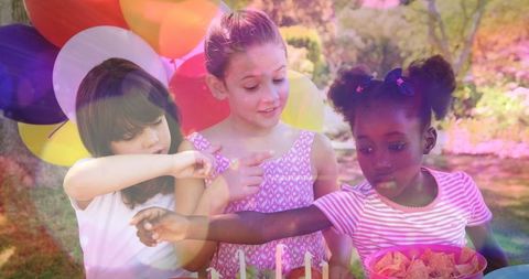 Joyful Children Celebrating Outdoors with Cake and Balloons