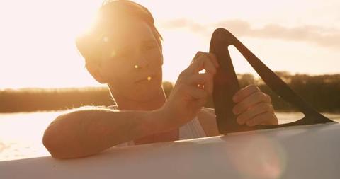 Man Preparing Boat for Sailing at Sunset - Download Free Stock Images Pikwizard.com