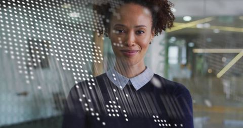 Businesswoman Analyzing Data in Modern Office with Global Infographic Overlay