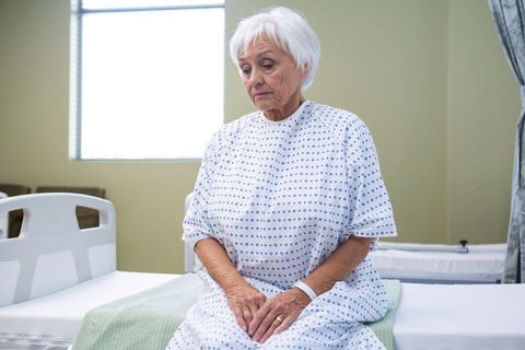 Elderly patient resting on hospital bed in tranquil room