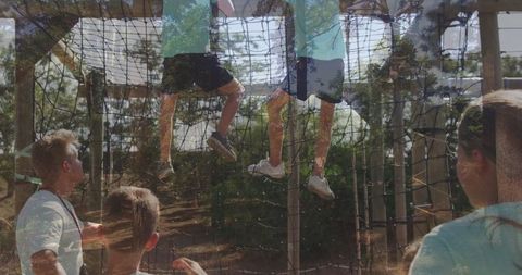 Children Climbing Adventure Course in Park with Safety Measures