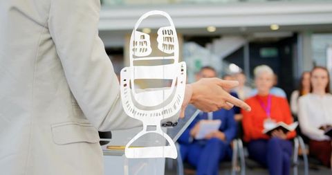 Business presenter pointing at audience behind clear lectern with corporate mic graphic