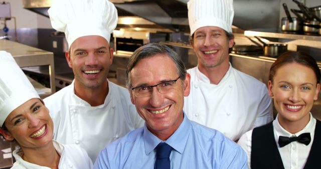 Smiling Chef Team with Manager in Professional Kitchen - Download Free Stock Images Pikwizard.com