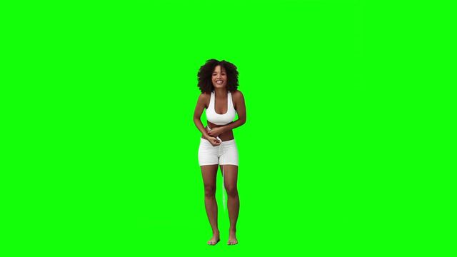 The woman, captured against a bright green background, is measuring her waist while smiling. This could be used in materials related to healthy lifestyle, weight loss, fitness goals, and wellness promotions. The green screen allows for easy editing and can be adapted for various marketing and educational uses.