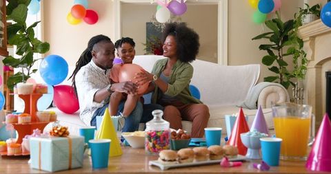 Family Celebrating Son's Birthday at Festive Home Party