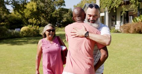 Senior Friends Reuniting Outdoors in Cheerful Embrace