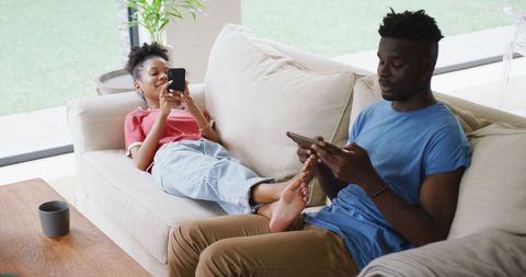 Relaxed African American Couple Enjoying Time Together with Gadgets - Download Free Stock Images Pikwizard.com