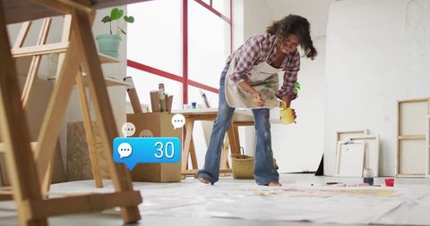 Creative artist painting in sunlit studio