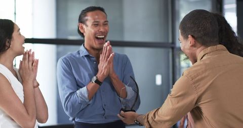 Cheerful Colleagues Celebrating Achievement with Award